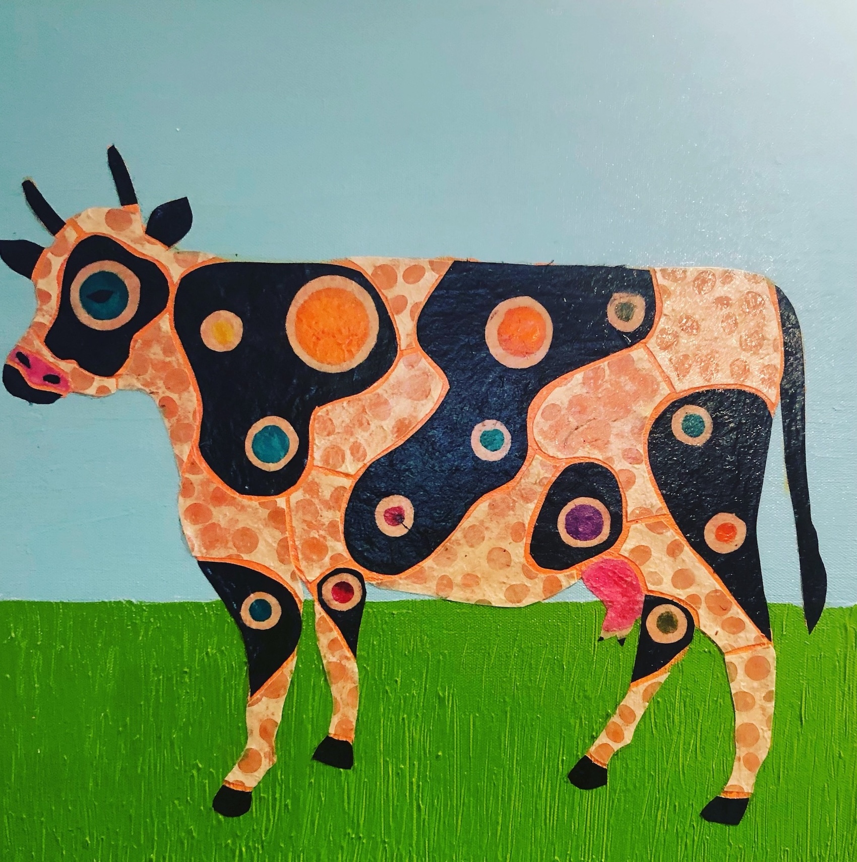 cow with colorful dots on its spots
