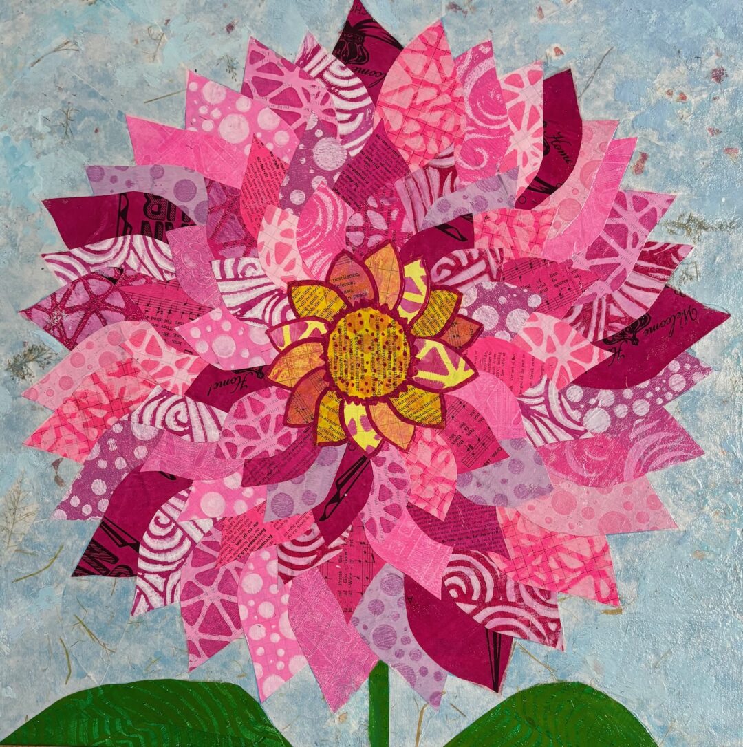 giant zinnia-like flower in pinks and magentas on patterned papers