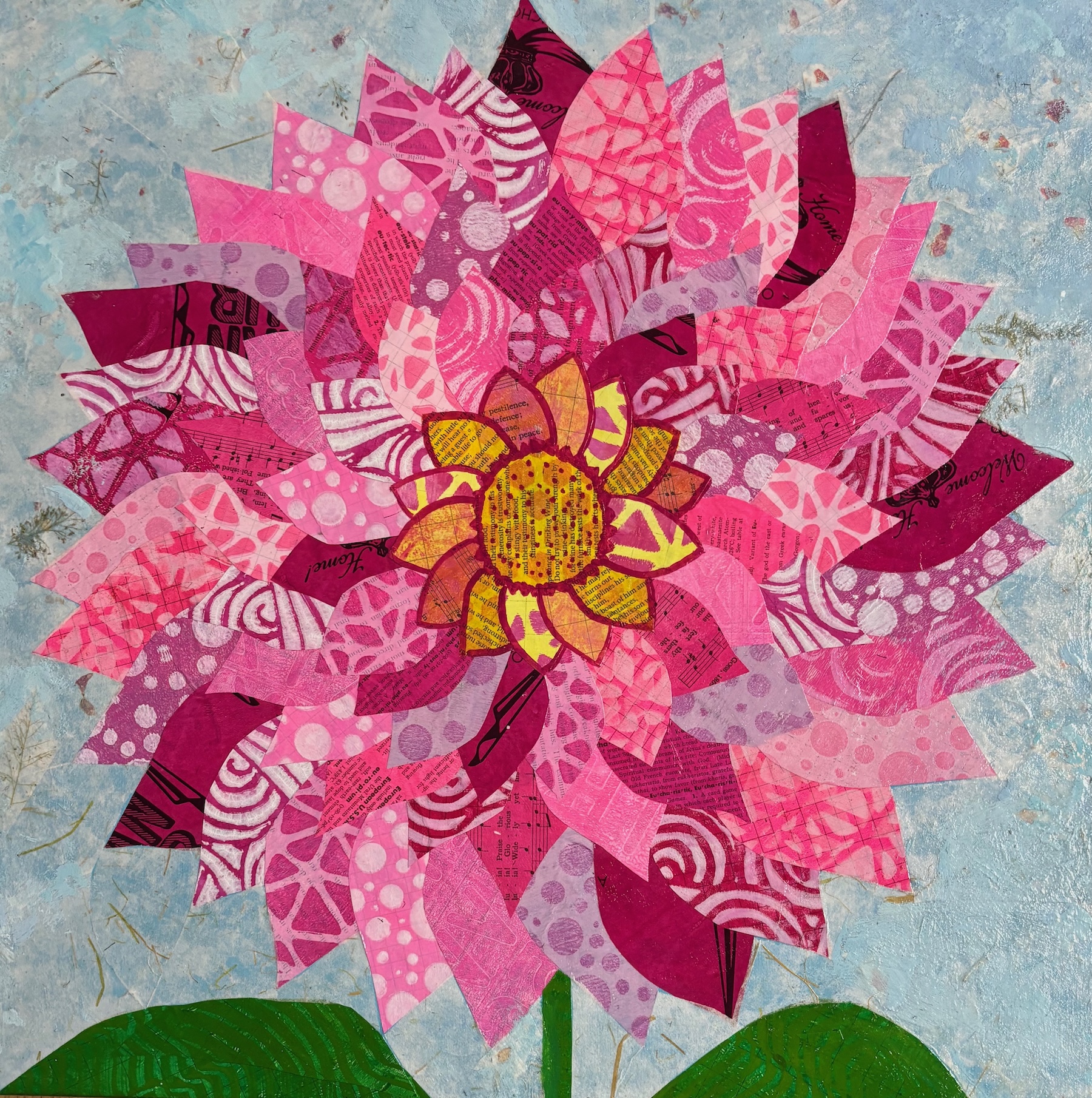 giant zinnia-like flower in pinks and magentas on patterned papers