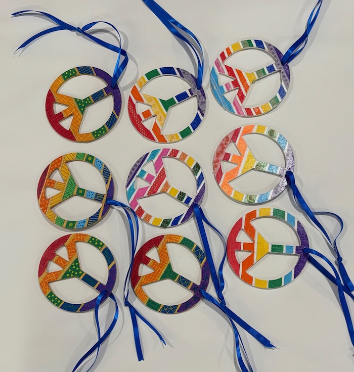 wooden rainbow colored peace symbols with ties